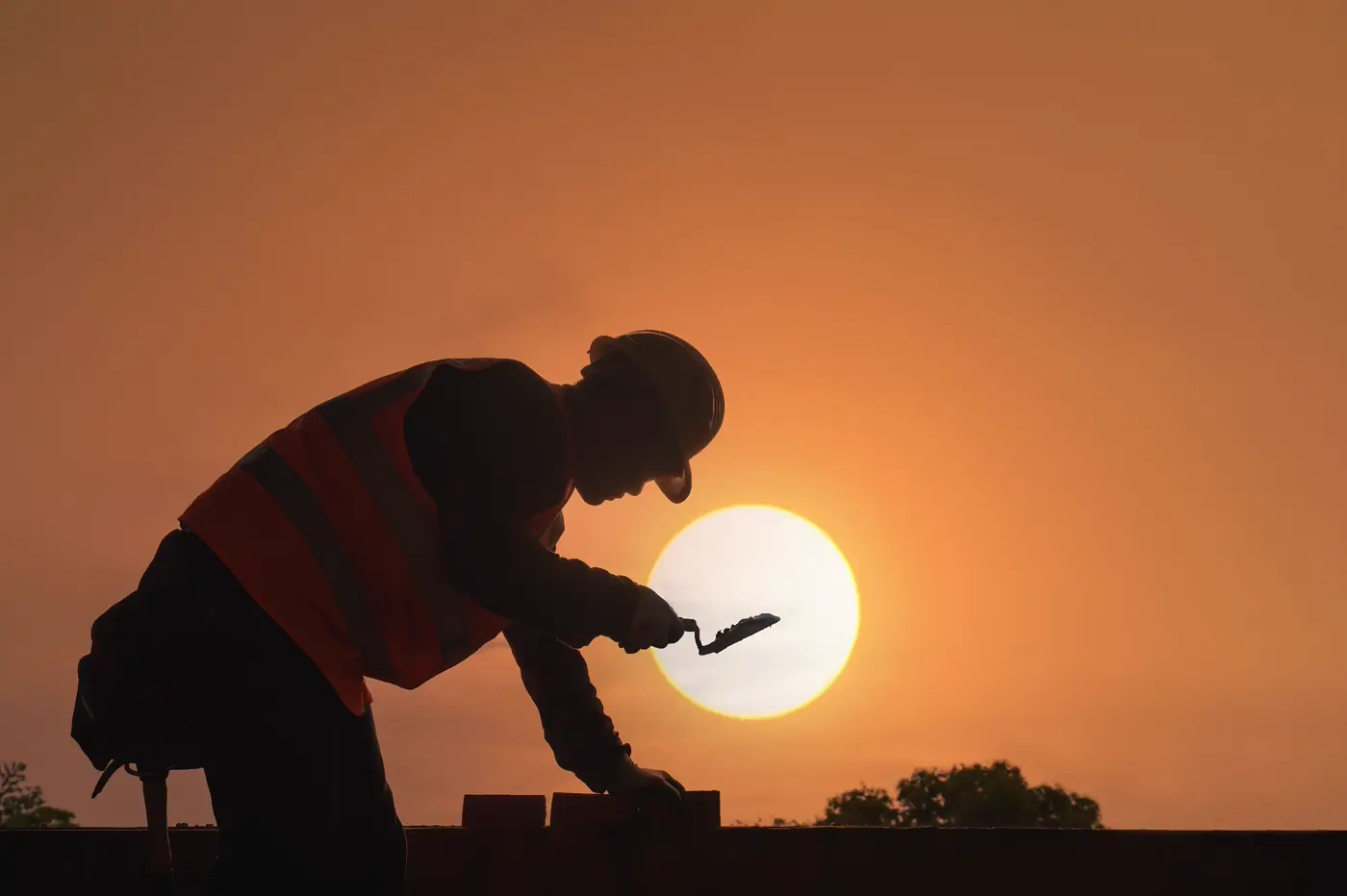 A craftsman at work on a residential exterior